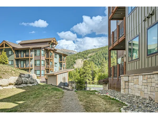 an aerial view of a house with yard porch and mountain view in back