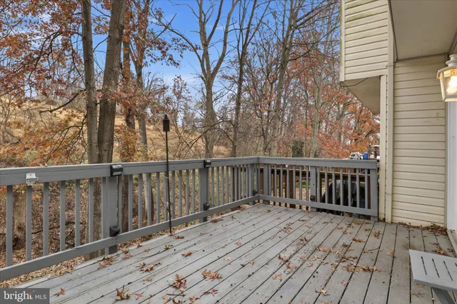 a balcony with wooden floor and fence