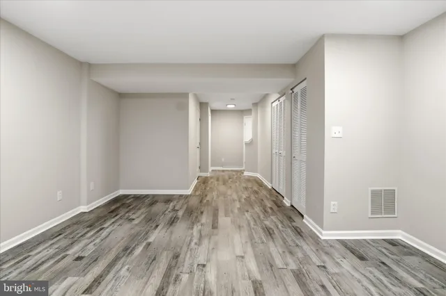 a view of hallway with wooden floor