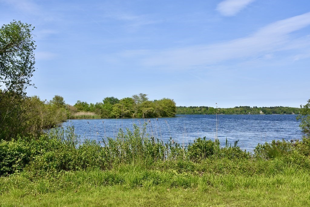 572 Snipatuit Road Rochester, MA 02770 - Photo 2 of 6 a view of a lake in a field