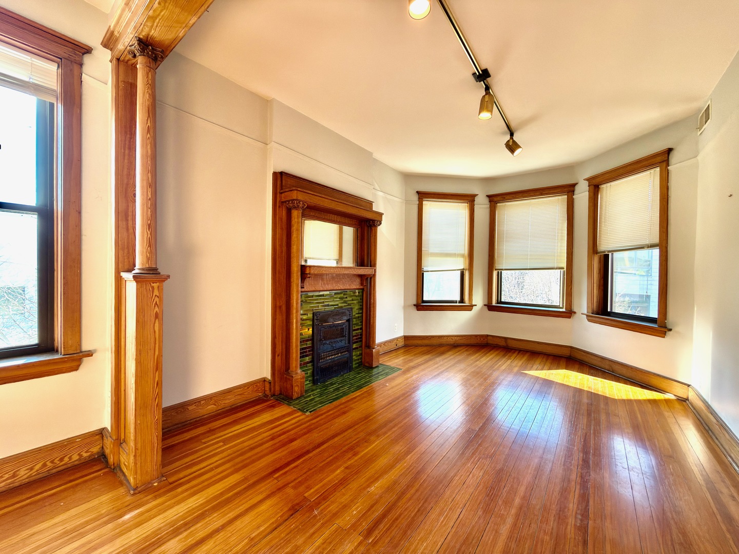 Undisclosed Address Chicago, IL 60647 - Photo 2 of 20 a view of an empty room with wooden floor and a window