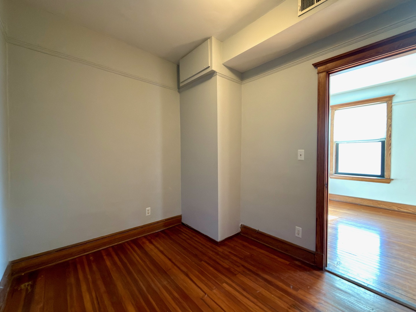 Undisclosed Address Chicago, IL 60647 - Photo 10 of 20 a view of an empty room with wooden floor and a window