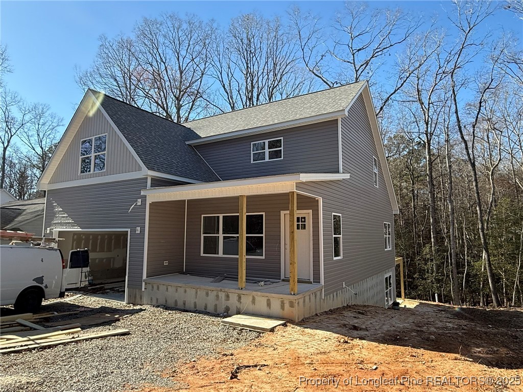 a front view of a house with a tree