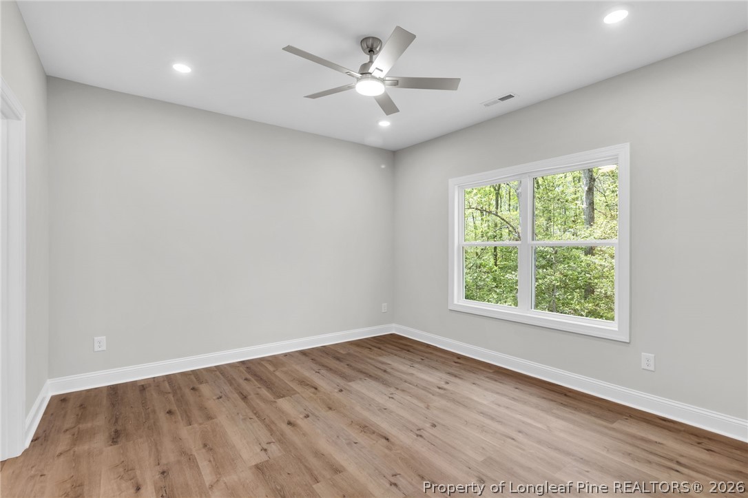 5130 Cardinal Circle Sanford, NC 27332 - Photo 15 of 45 an empty room with wooden floor and windows