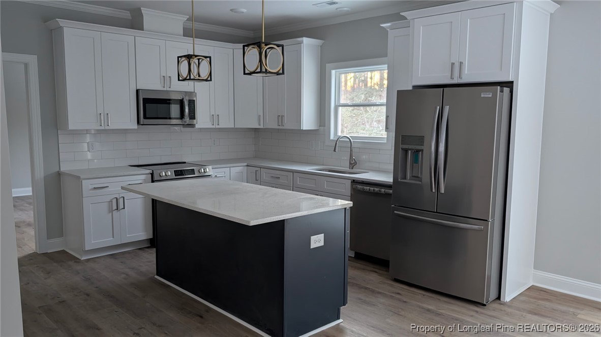 5130 Cardinal Circle Sanford, NC 27332 - Photo 17 of 36 a kitchen with stainless steel appliances granite countertop a refrigerator a sink a stove and microwave