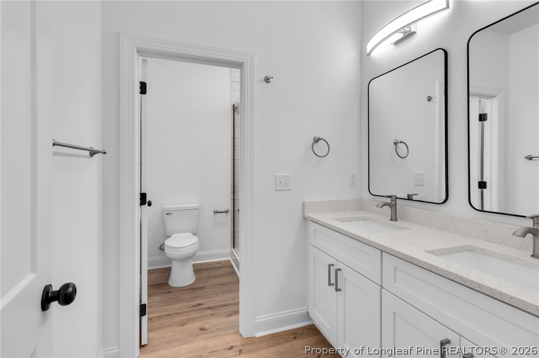 5130 Cardinal Circle Sanford, NC 27332 - Photo 18 of 45 a bathroom with a granite countertop sink toilet and shower