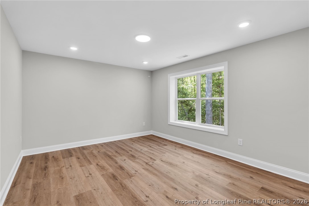 5130 Cardinal Circle Sanford, NC 27332 - Photo 26 of 45 an empty room with wooden floor and windows