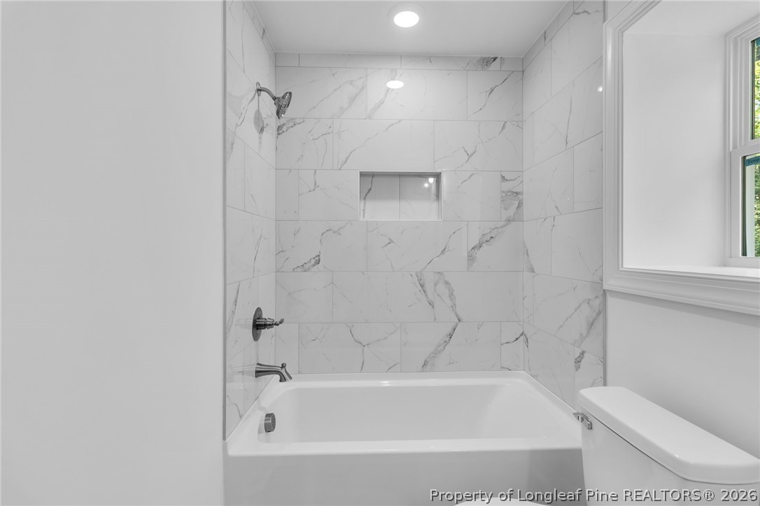 5130 Cardinal Circle Sanford, NC 27332 - Photo 29 of 45 a bathroom with a bathtub and a toilet
