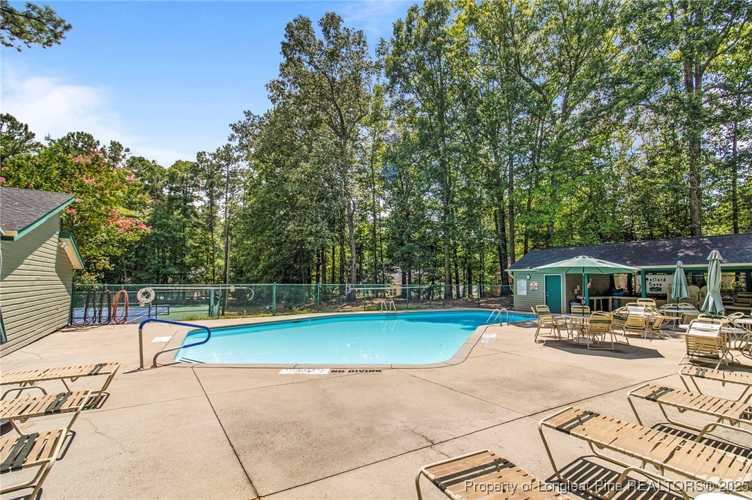 5130 Cardinal Circle Sanford, NC 27332 - Photo 33 of 36 a view of a swimming pool with a patio