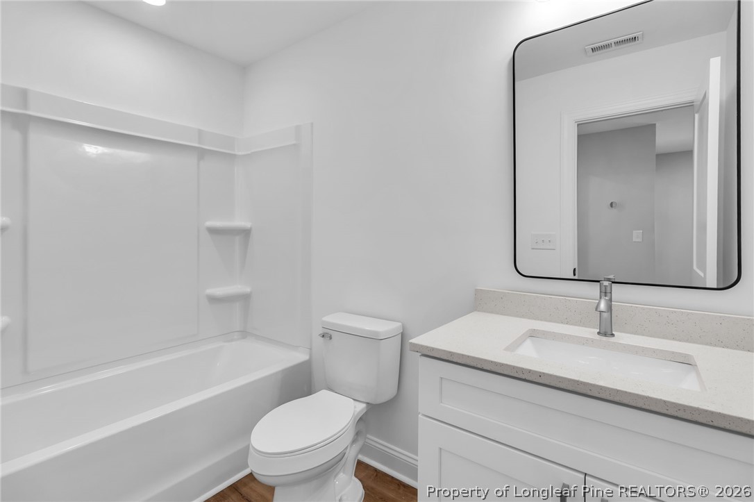 5130 Cardinal Circle Sanford, NC 27332 - Photo 36 of 45 a bathroom with a sink a toilet and a bathtub
