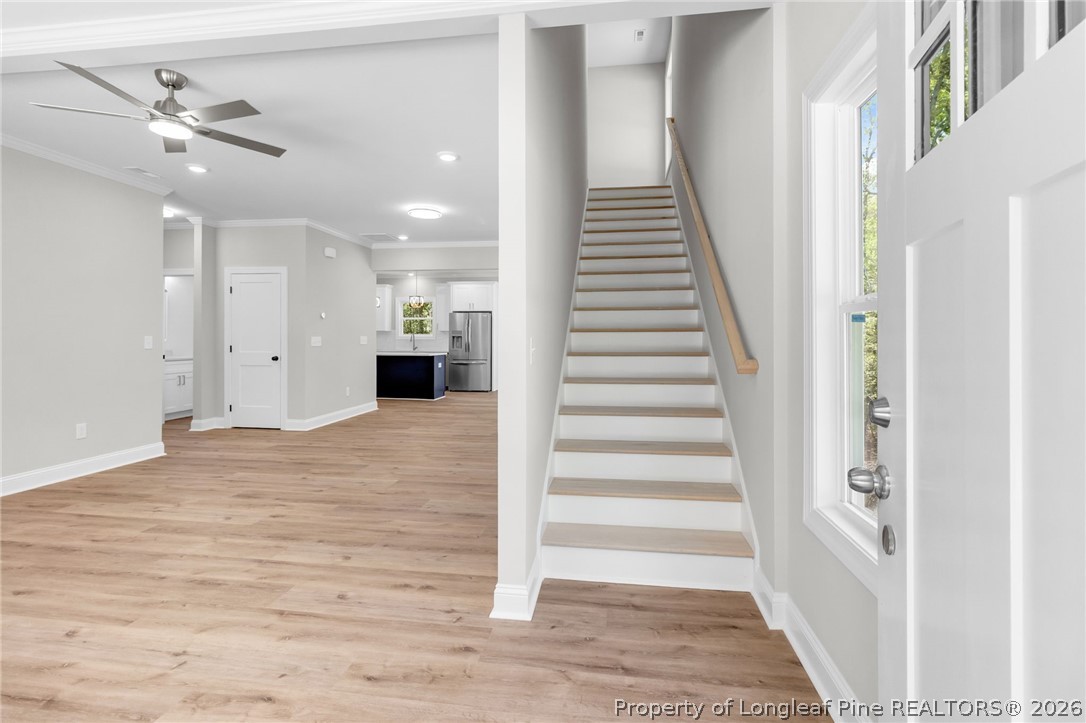 5130 Cardinal Circle Sanford, NC 27332 - Photo 5 of 45 a view of a hallway with wooden floor and staircase