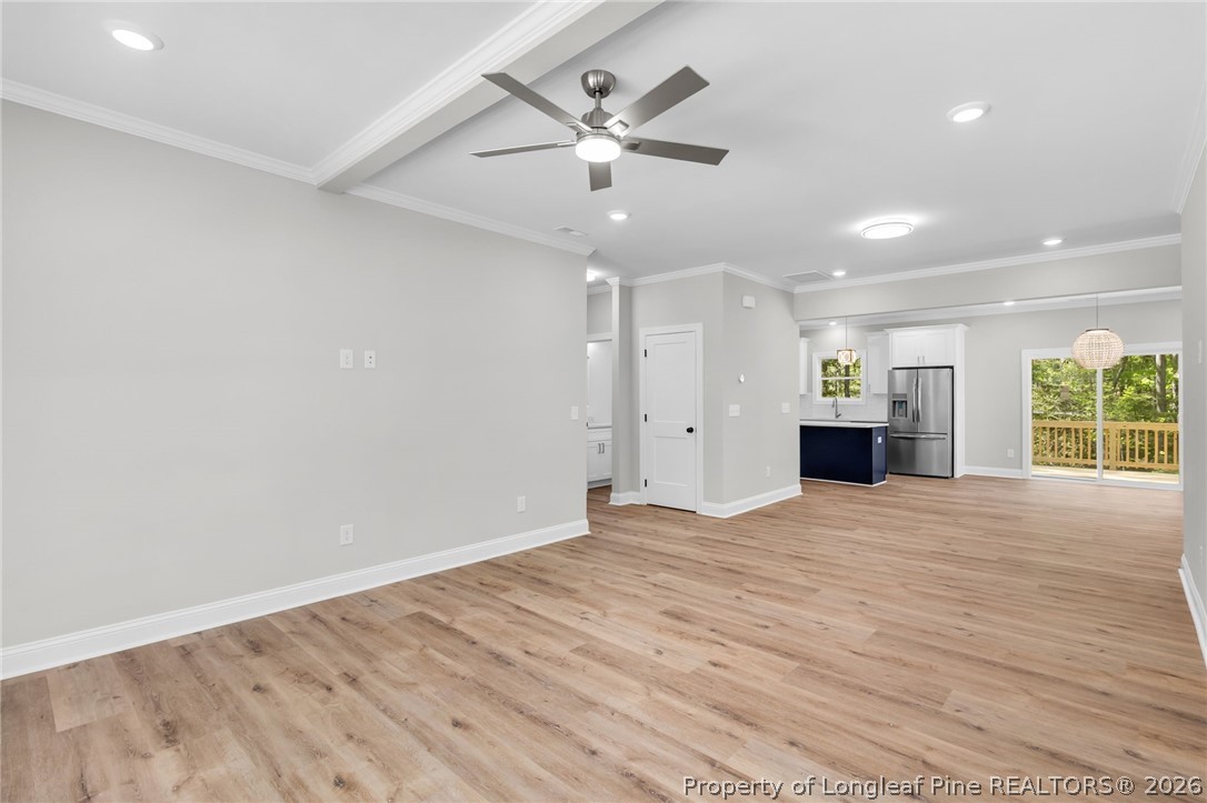 5130 Cardinal Circle Sanford, NC 27332 - Photo 6 of 45 an empty room with wooden floor ceiling fan and windows