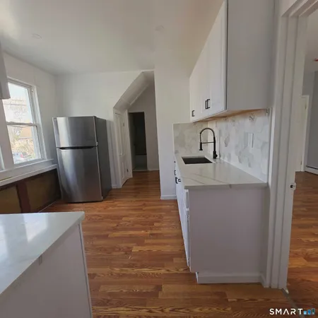 a kitchen with refrigerator and window