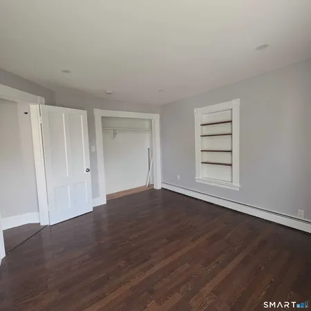 a view of wooden floor and windows in a room