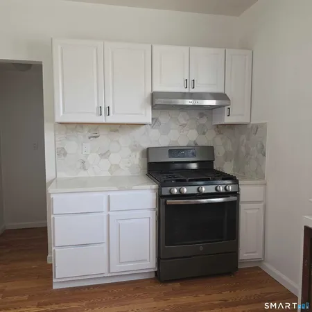 a stove top oven sitting inside of a kitchen