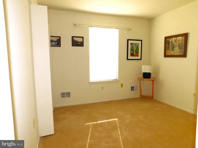 a view of a livingroom with an empty space and a window