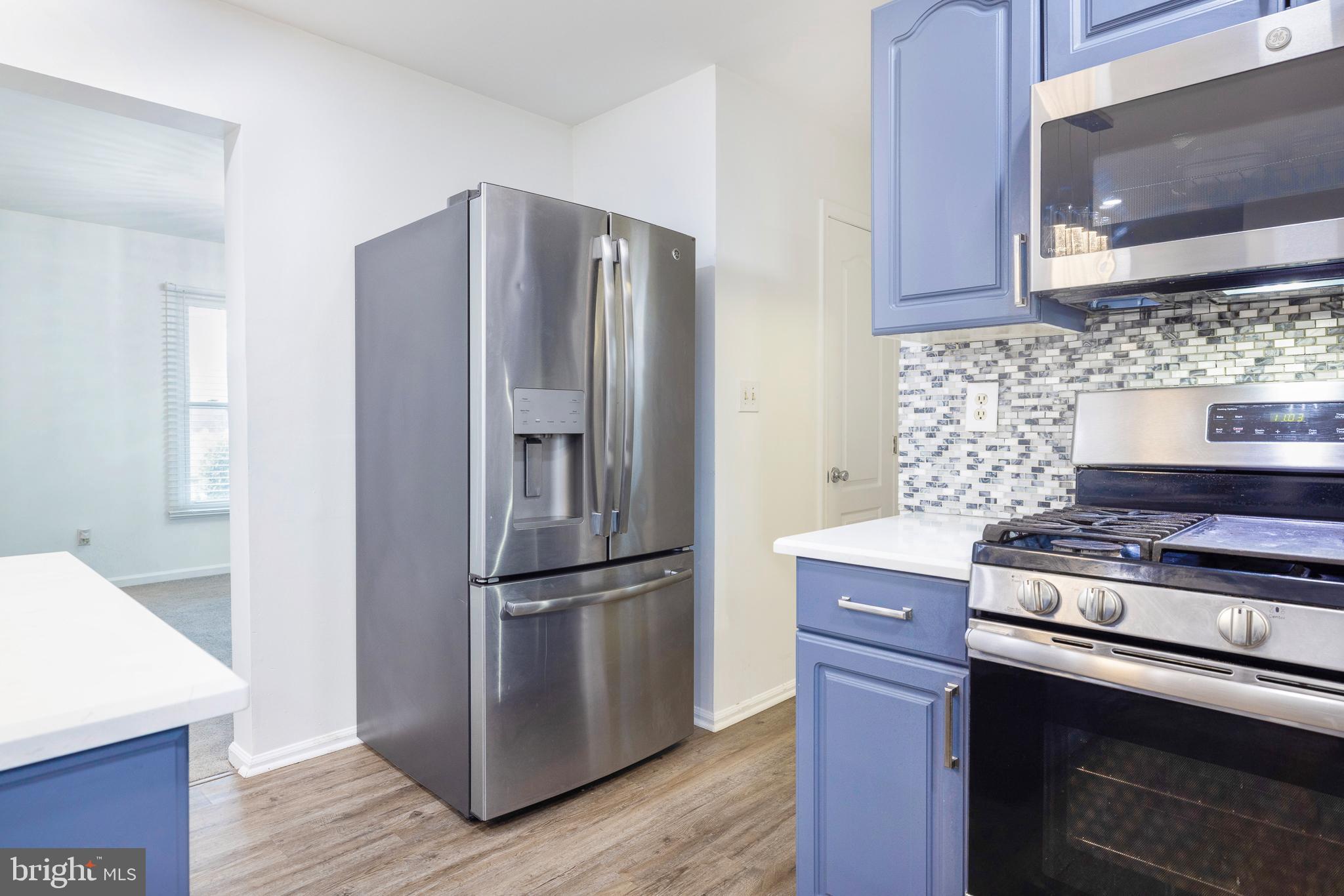 93 Nursery Drive Bear, DE 19701 - Photo 12 of 43 a kitchen with granite countertop a refrigerator stove and microwave