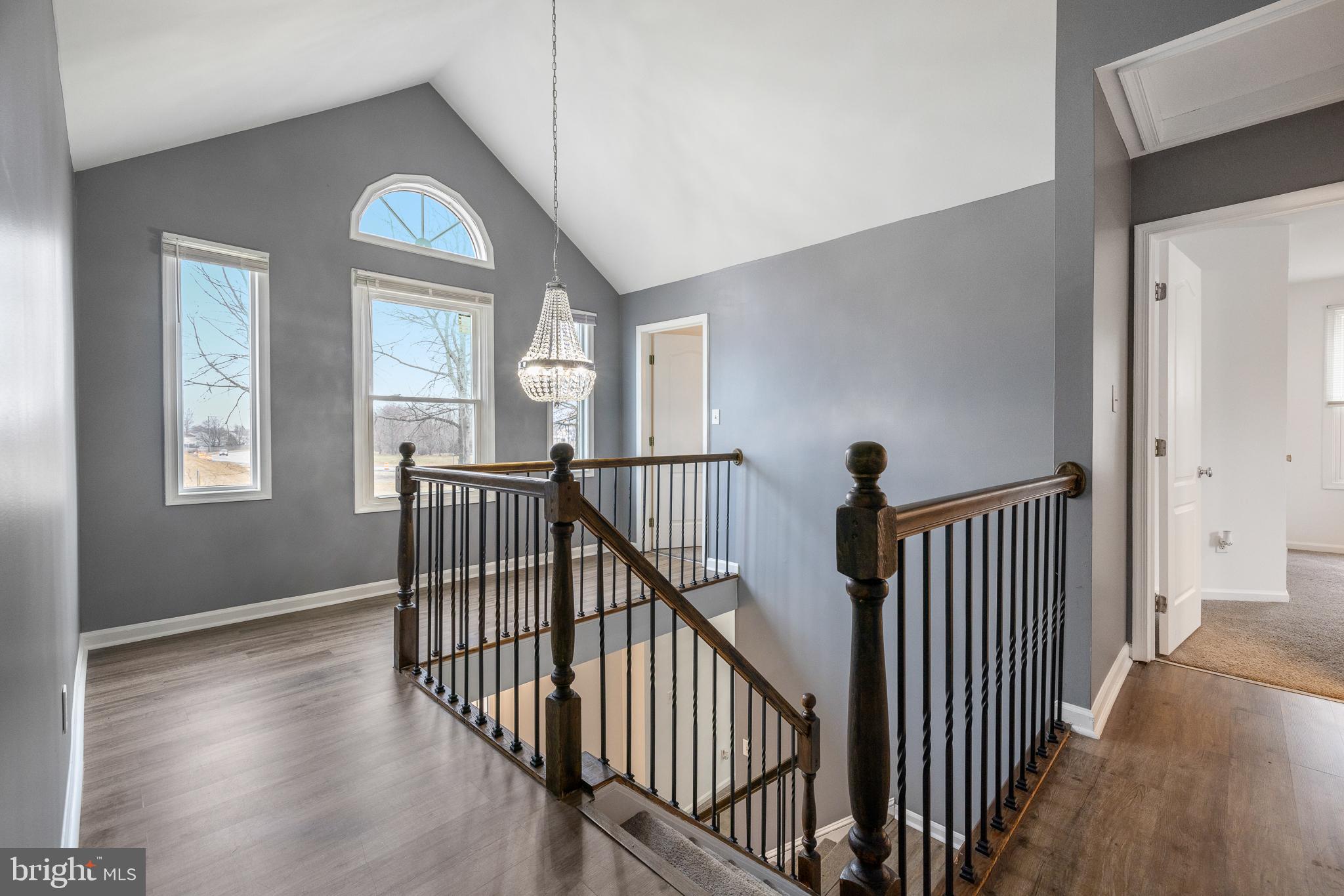 93 Nursery Drive Bear, DE 19701 - Photo 14 of 43 a view of a hallway with wooden floor and stairs