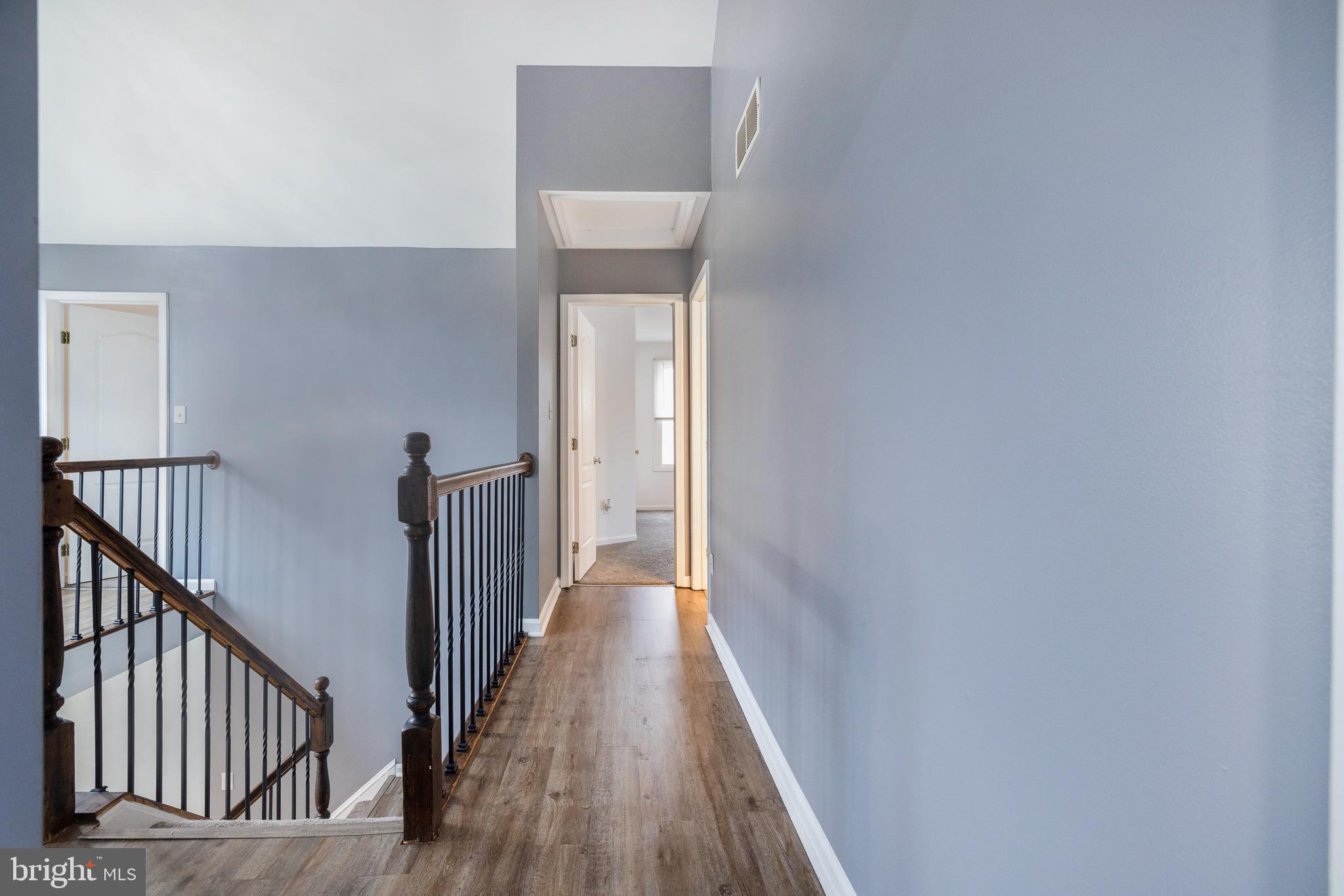 93 Nursery Drive Bear, DE 19701 - Photo 25 of 43 a view of a hallway with wooden floor and staircase