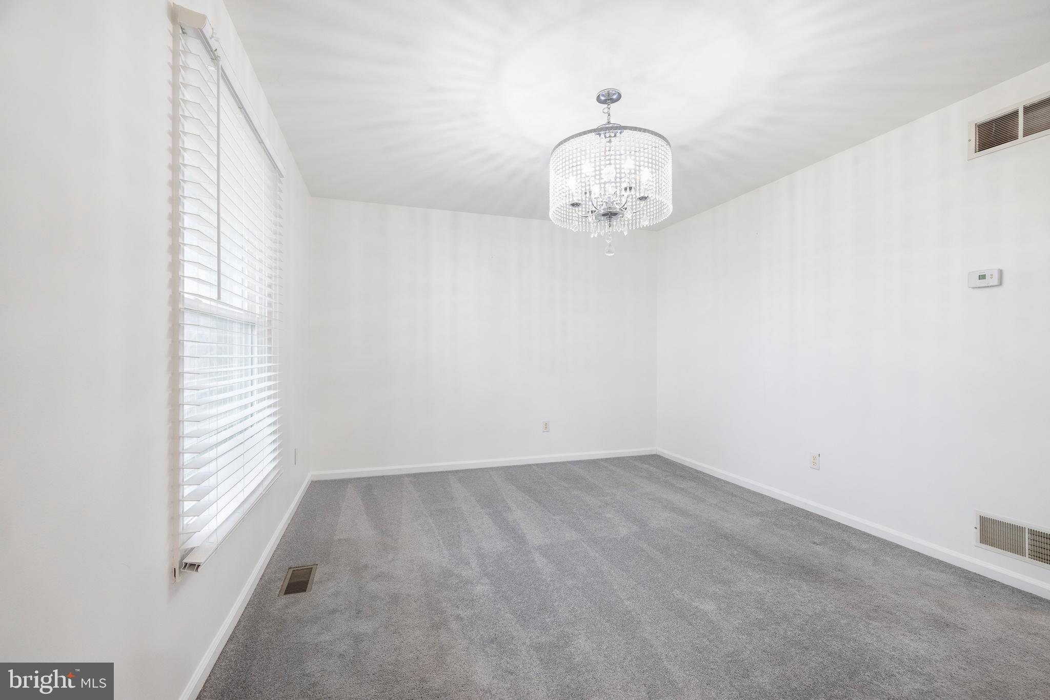 93 Nursery Drive Bear, DE 19701 - Photo 3 of 43 an empty room with wooden floor and windows