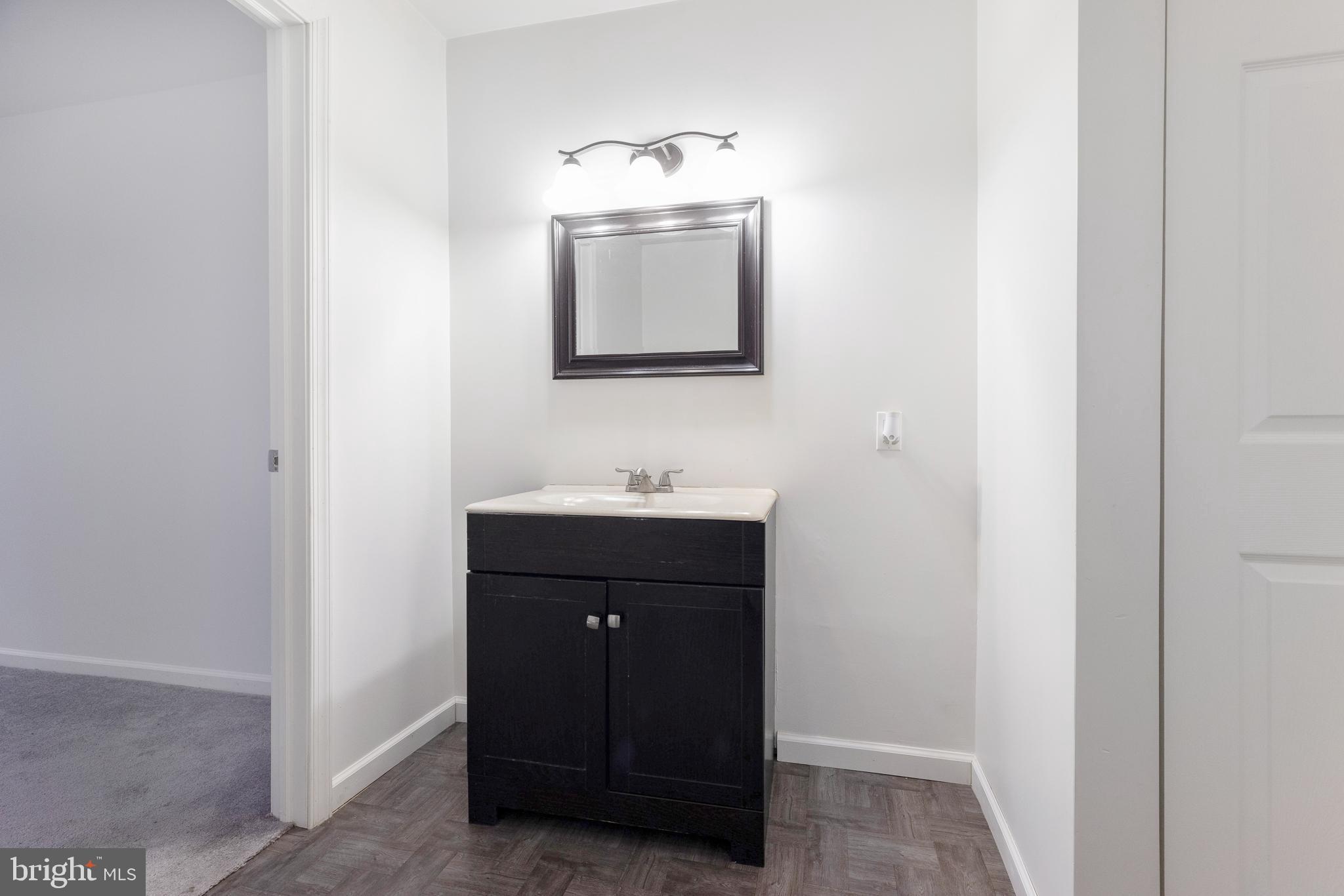 93 Nursery Drive Bear, DE 19701 - Photo 38 of 43 a bathroom with a sink and a mirror