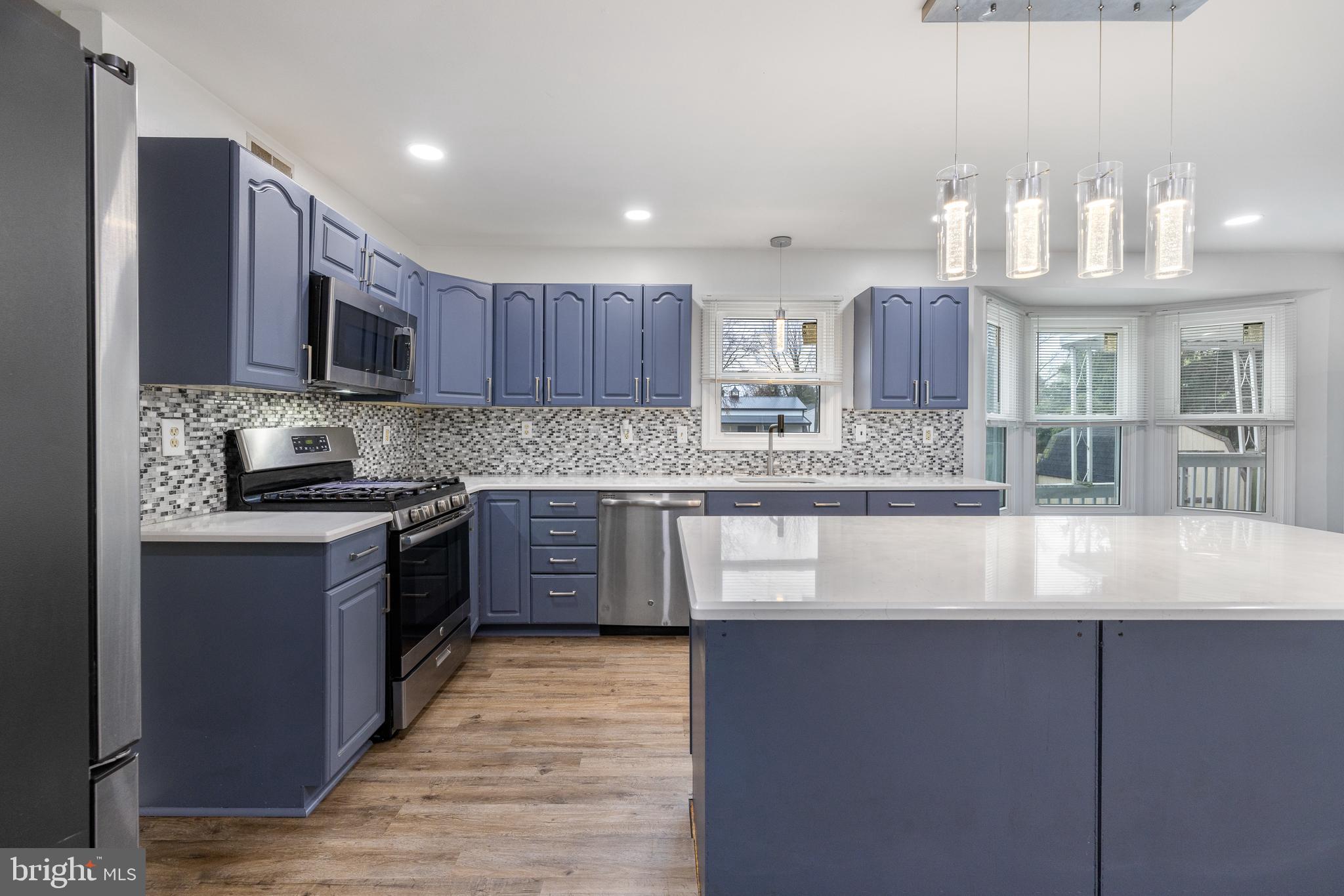 93 Nursery Drive Bear, DE 19701 - Photo 5 of 43 a kitchen with stainless steel appliances granite countertop wooden cabinets a stove a sink and a granite counter top
