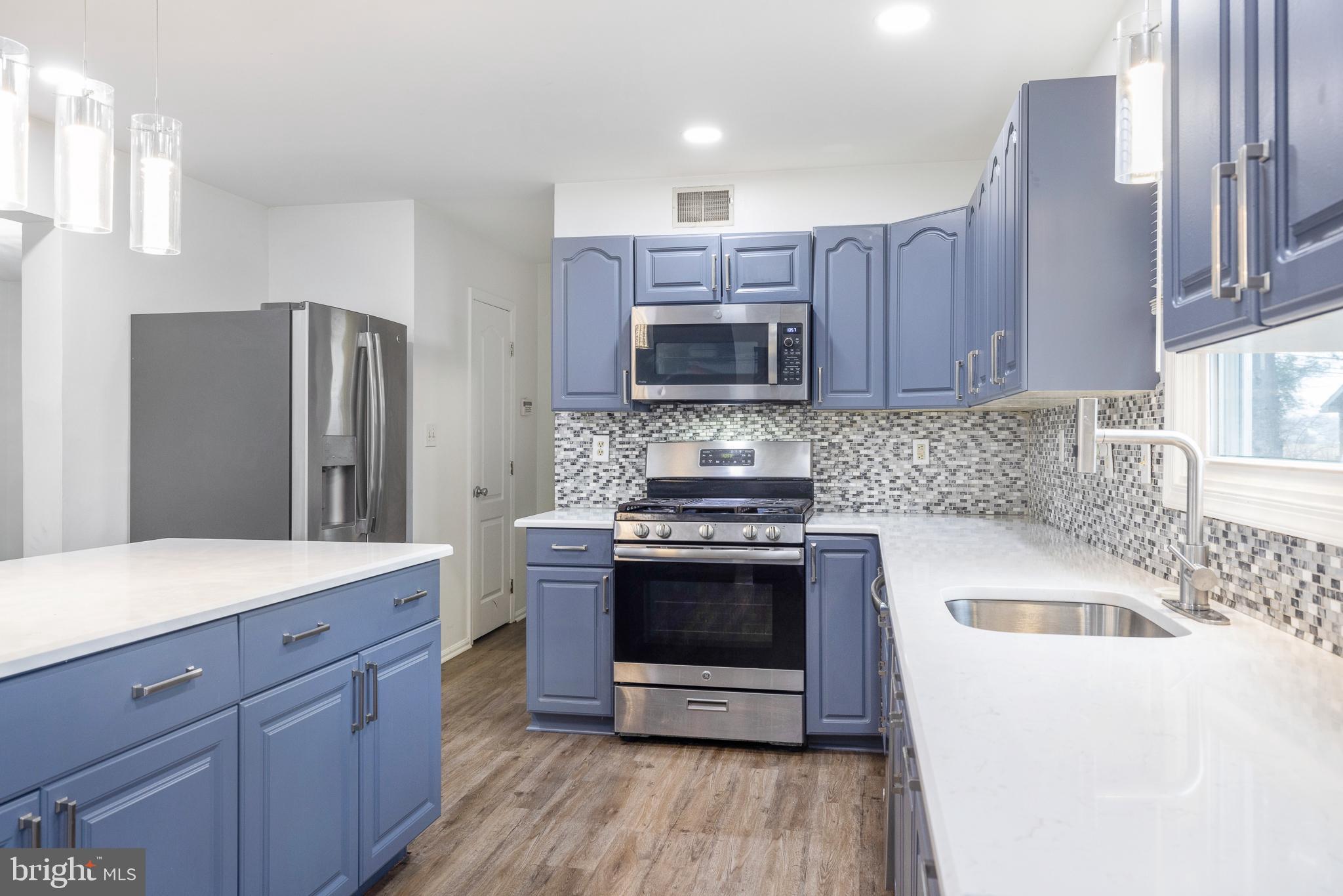 93 Nursery Drive Bear, DE 19701 - Photo 8 of 43 a kitchen with a sink stove and refrigerator