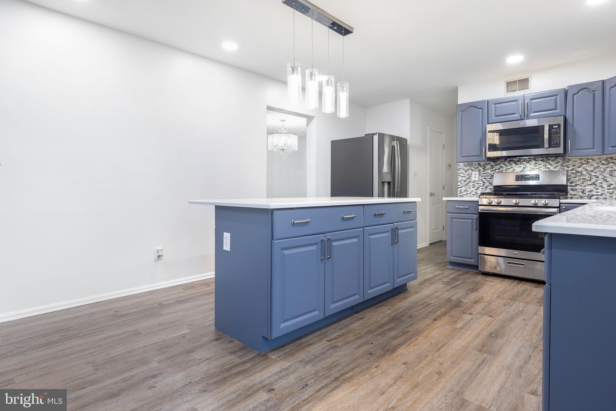 93 Nursery Drive Bear, DE 19701 - Photo 9 of 43 a kitchen with stainless steel appliances granite countertop a stove a sink and a refrigerator