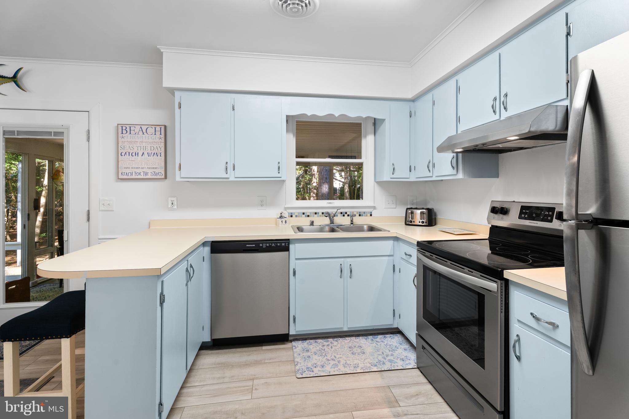 85 Ocean Parkway Ocean Pines, MD 21811 - Photo 16 of 78 a kitchen with stainless steel appliances granite countertop a sink and dishwasher a stove top oven with white countertops