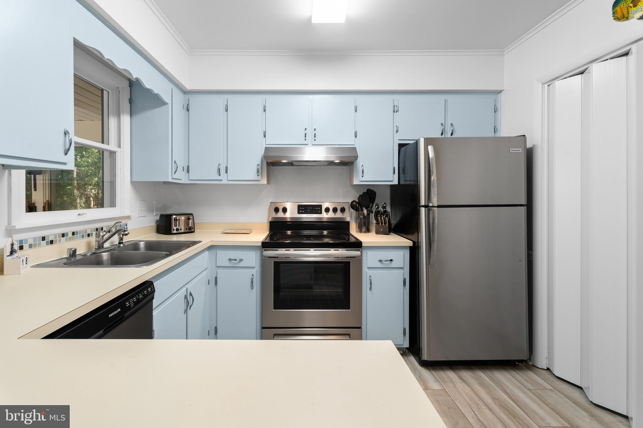 85 Ocean Parkway Ocean Pines, MD 21811 - Photo 18 of 78 a kitchen with a refrigerator sink and cabinets