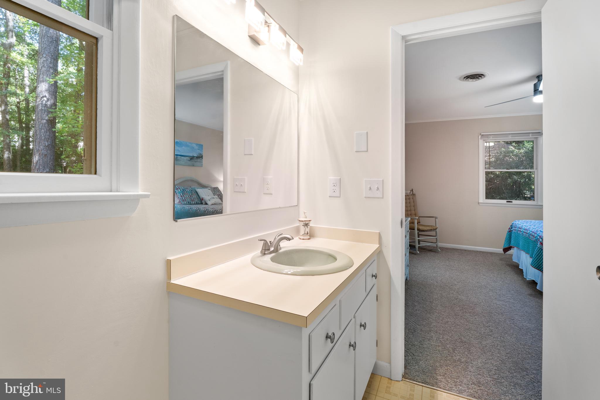 85 Ocean Parkway Ocean Pines, MD 21811 - Photo 33 of 78 a bathroom with a sink and a mirror