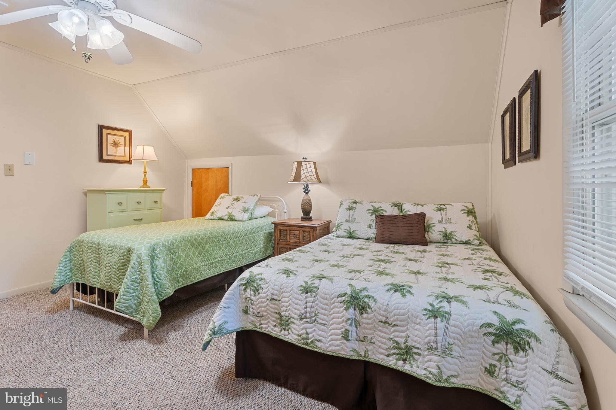 85 Ocean Parkway Ocean Pines, MD 21811 - Photo 46 of 78 a bedroom with two beds and a chandelier