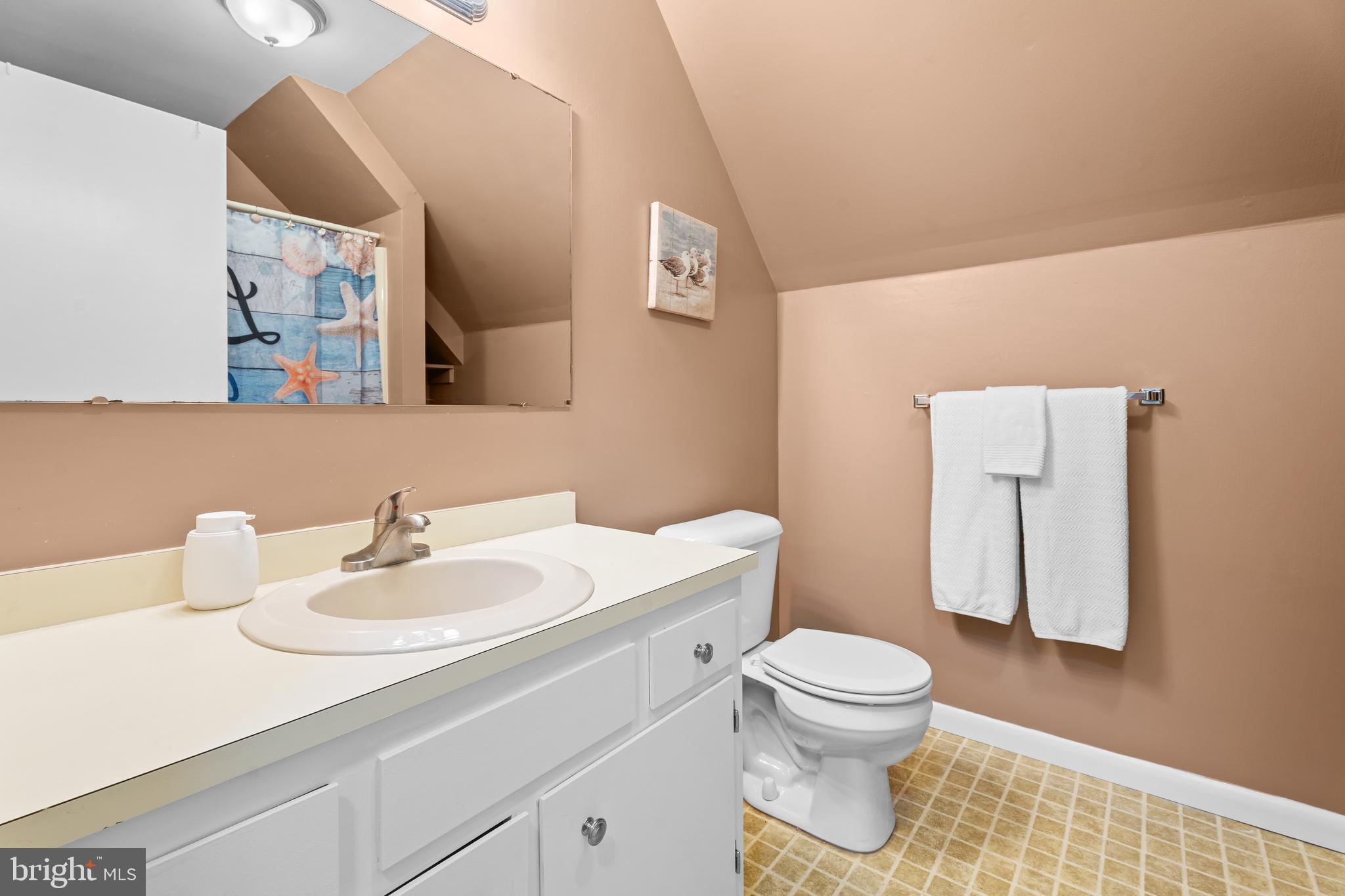 85 Ocean Parkway Ocean Pines, MD 21811 - Photo 49 of 78 a bathroom with a sink a toilet and mirror