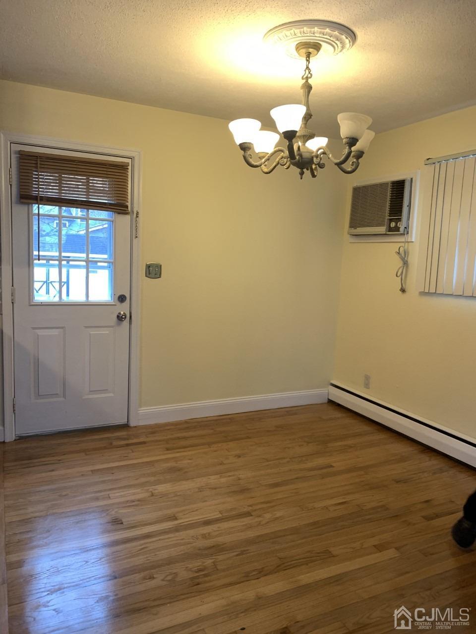20 Finley Road Edison, NJ 08817 - Photo 13 of 16 wooden floor in an empty room with a window