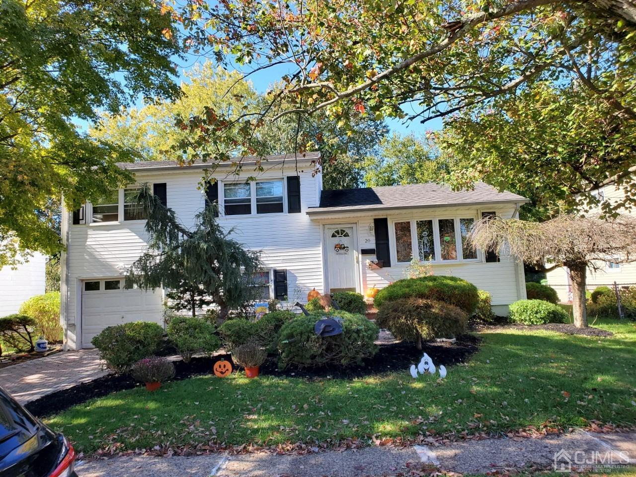 20 Finley Road Edison, NJ 08817 - Photo 3 of 16 a front view of a house with a garden and trees