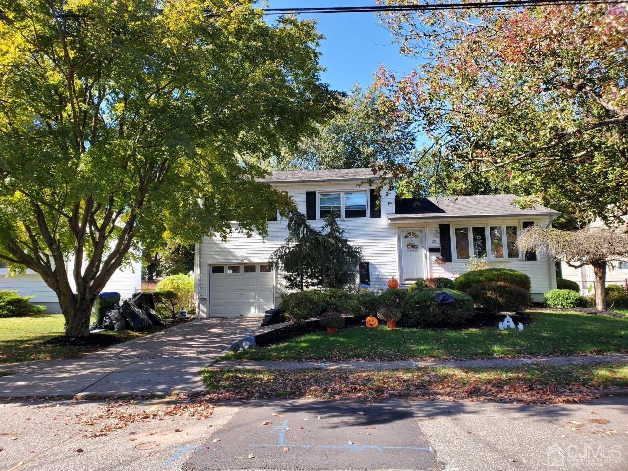 20 Finley Road Edison, NJ 08817 - Photo 8 of 16 a front view of a house with a garden and trees