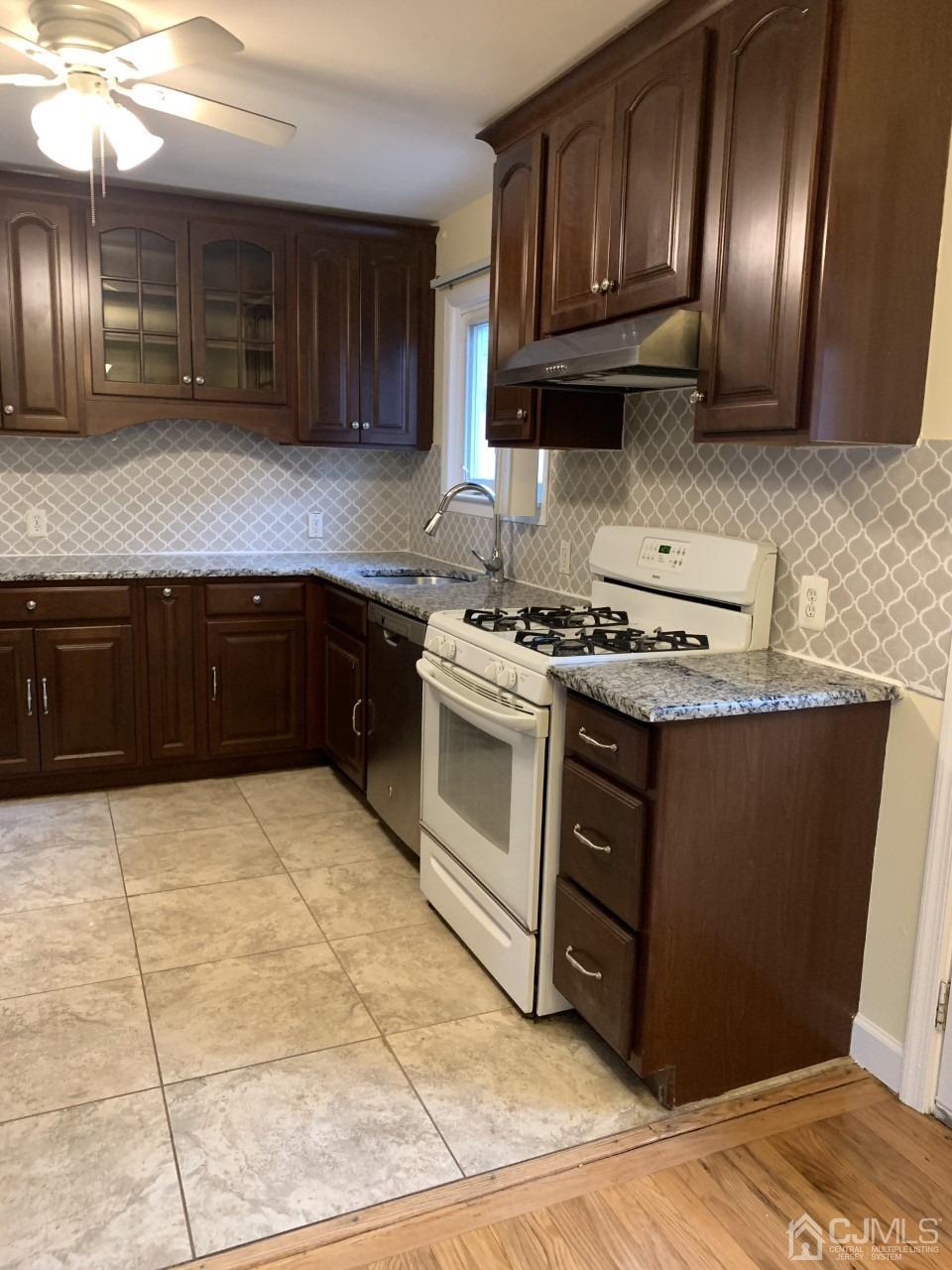 20 Finley Road Edison, NJ 08817 - Photo 9 of 16 a kitchen with stainless steel appliances granite countertop a stove a sink and a microwave