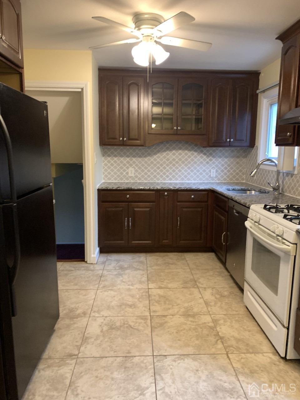 20 Finley Road Edison, NJ 08817 - Photo 10 of 16 a kitchen with stainless steel appliances granite countertop a stove a sink and a microwave