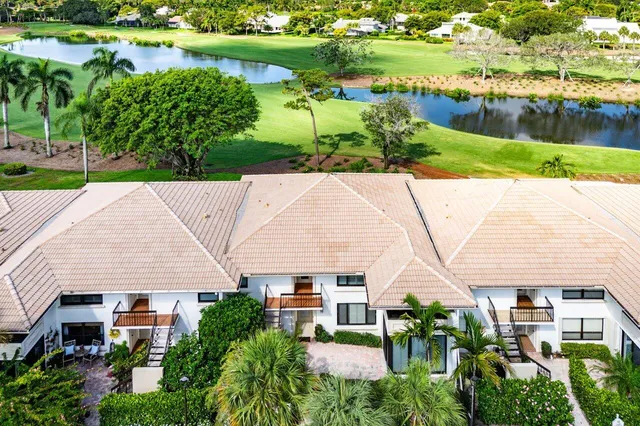 an aerial view of a house with a yard and outdoor seating