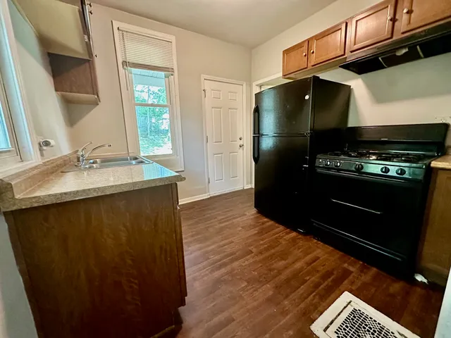 a kitchen with a sink stainless steel appliances and cabinets