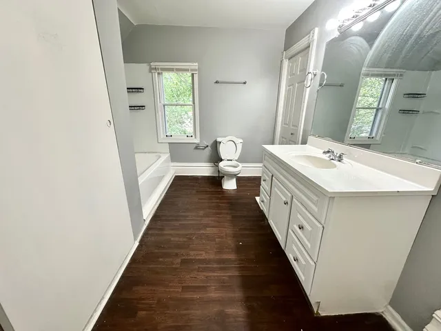 a bathroom with a double vanity sink and a mirror