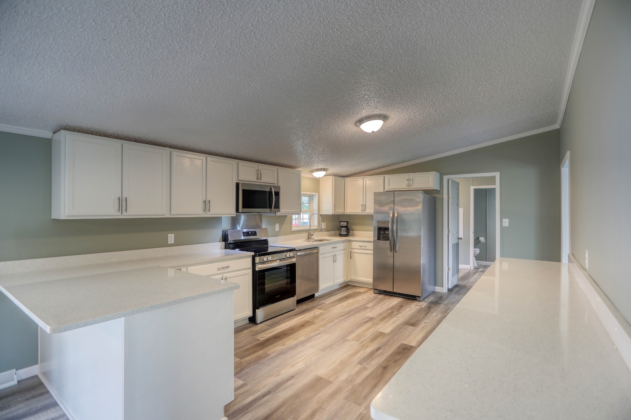 1834 Oak Grove Church Road Adolphus, KY 42120 - Photo 12 of 31 a kitchen with a refrigerator a stove top oven a sink dishwasher and wooden cabinets