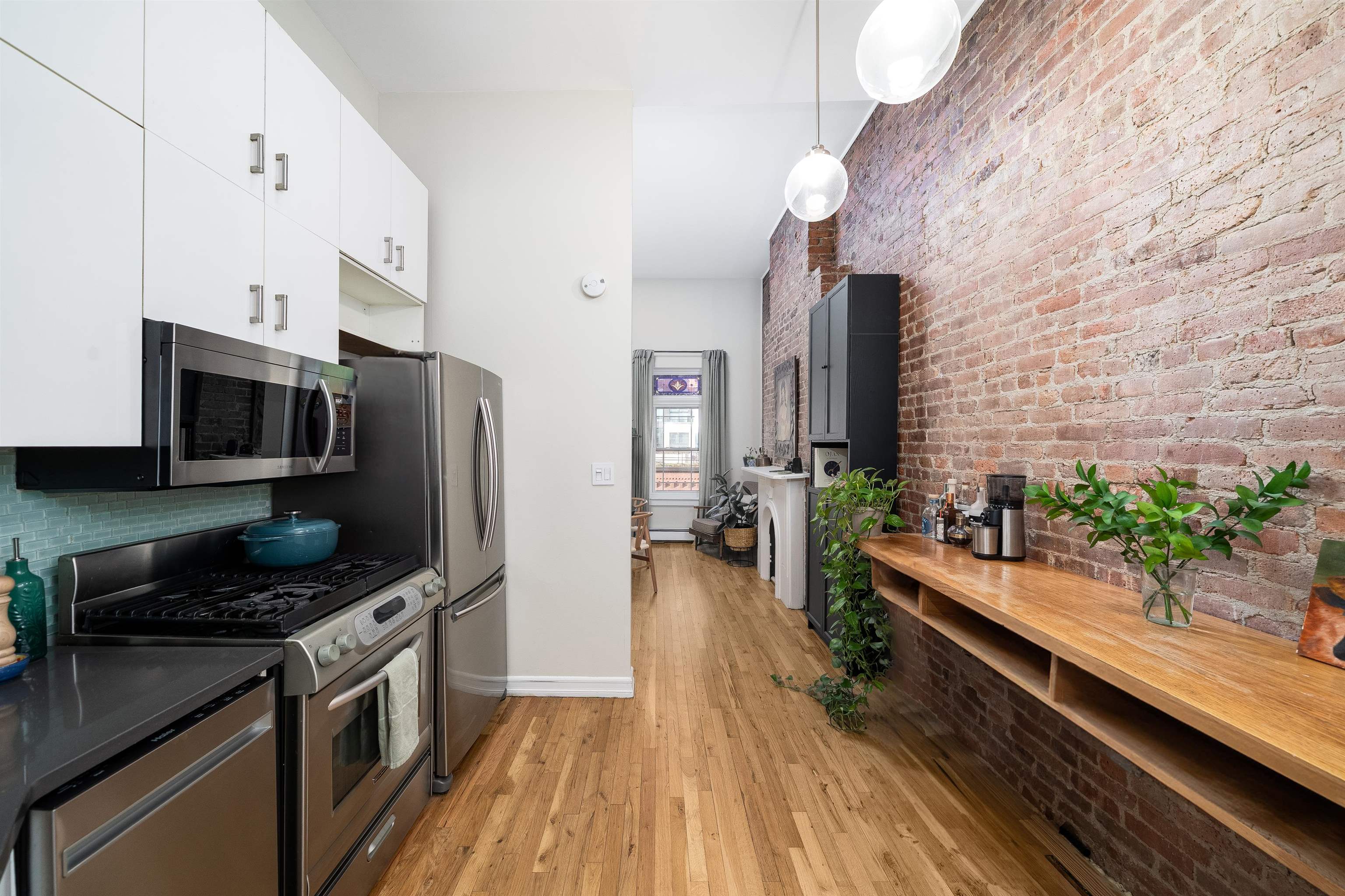205 14th Street, Unit 4F Hoboken, NJ 07030 - Photo 11 of 22 a kitchen with stainless steel appliances a stove a sink and a refrigerator