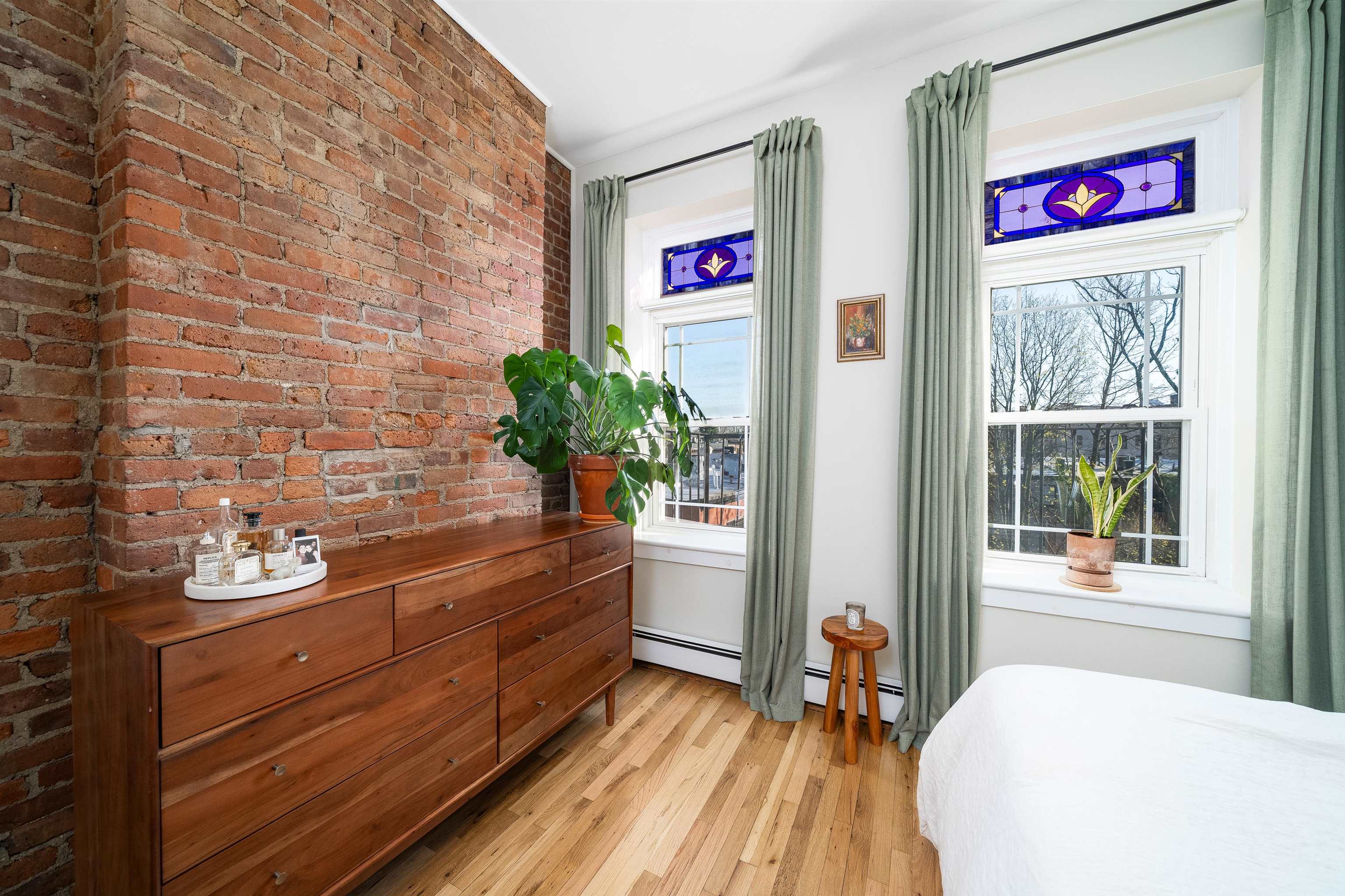 205 14th Street, Unit 4F Hoboken, NJ 07030 - Photo 16 of 22 a bed room with a bed and a potted plant