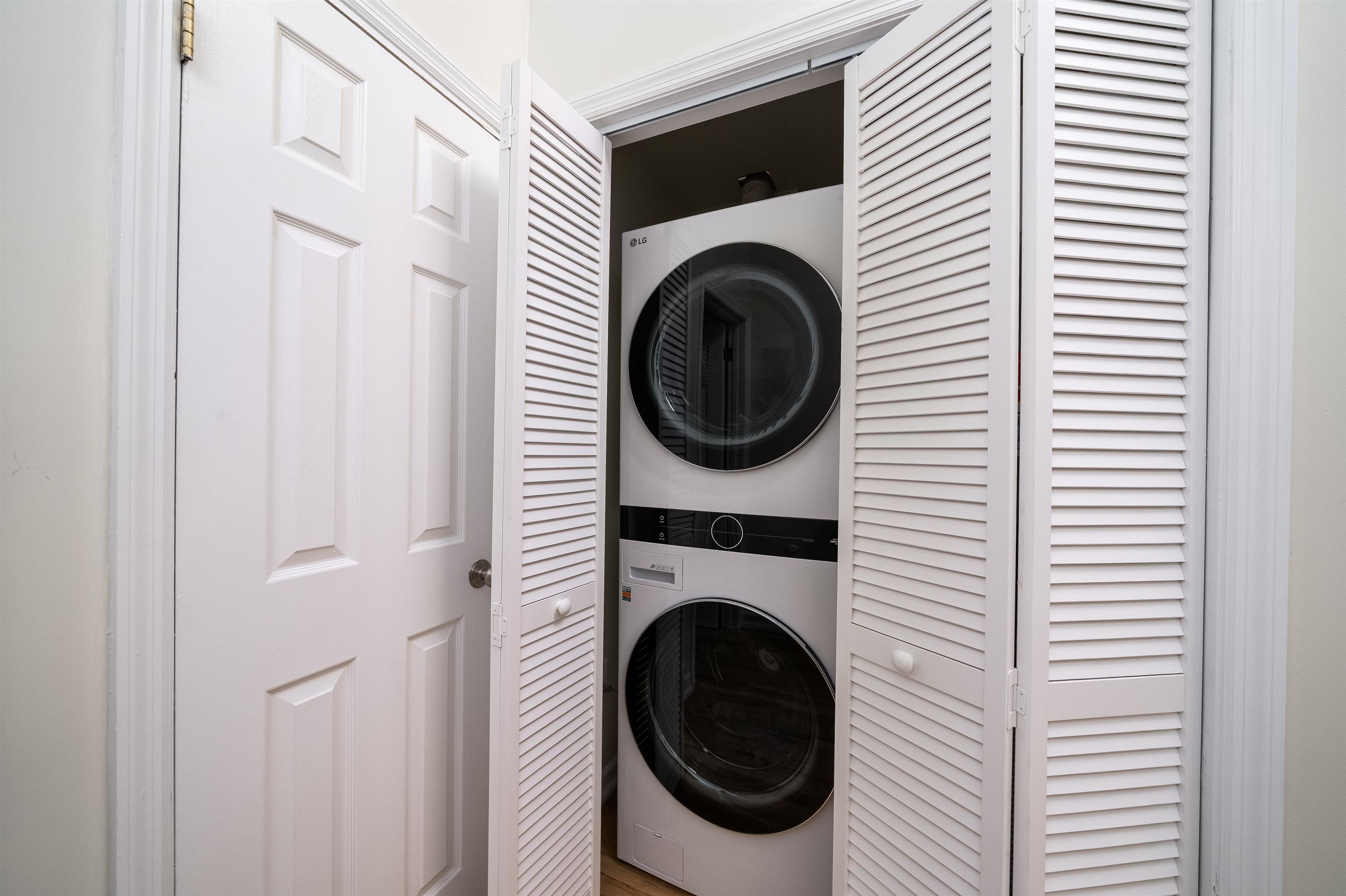 205 14th Street, Unit 4F Hoboken, NJ 07030 - Photo 18 of 22 a view of a hallway with washer and dryer