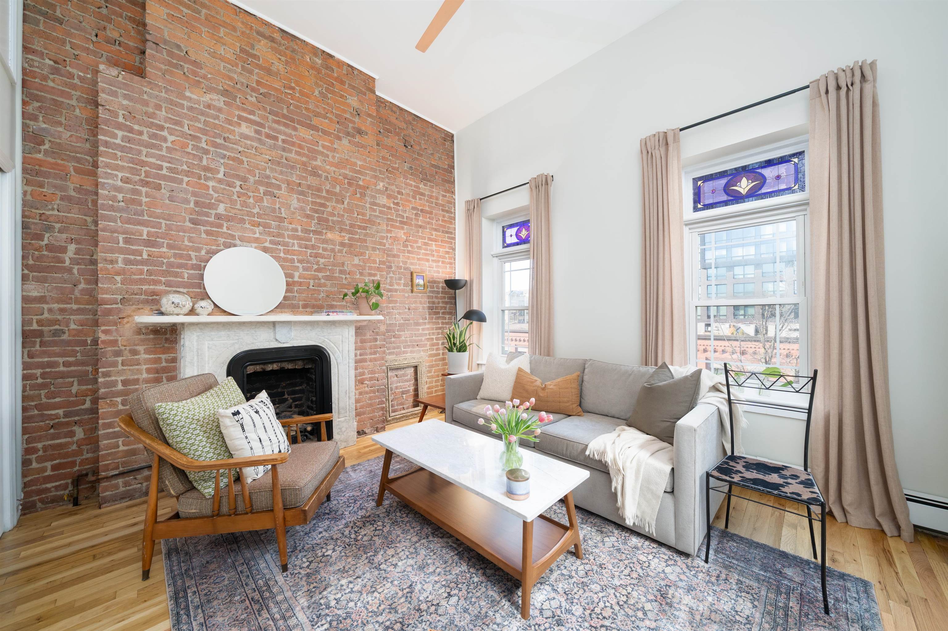 205 14th Street, Unit 4F Hoboken, NJ 07030 - Photo 2 of 22 a living room with furniture a fireplace and a large window