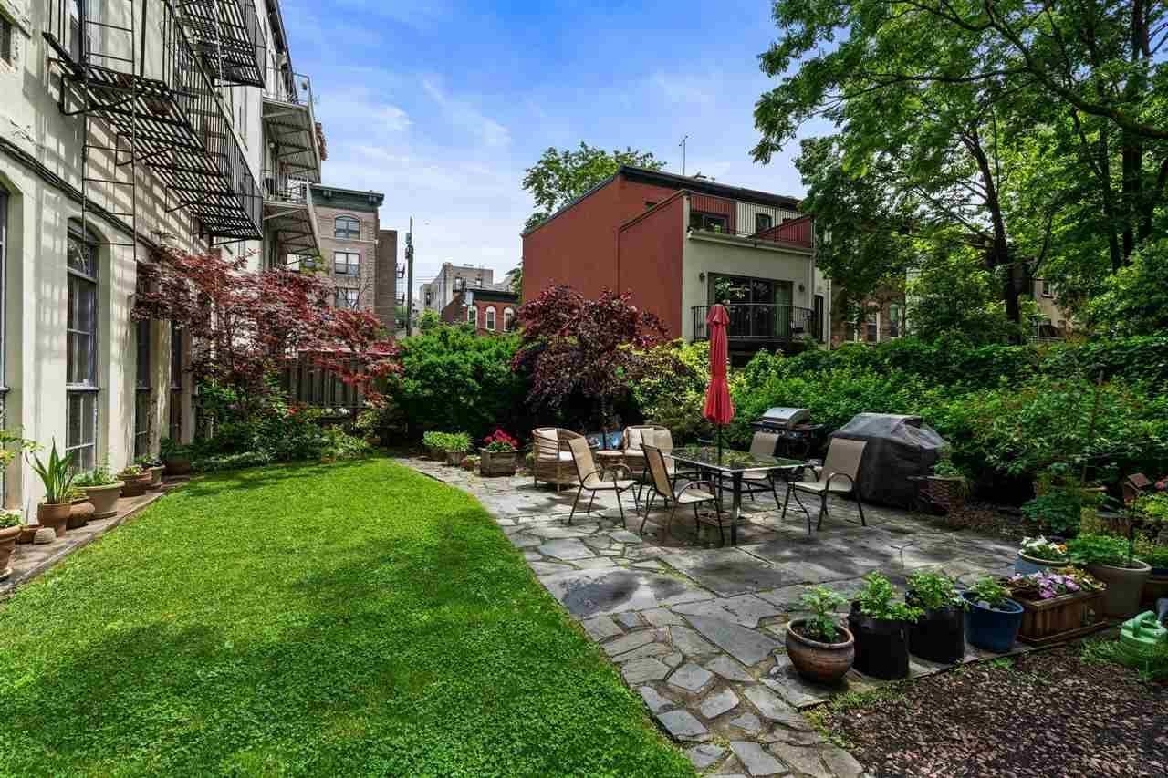 205 14th Street, Unit 4F Hoboken, NJ 07030 - Photo 21 of 22 a view of a patio with table and chairs and potted plants