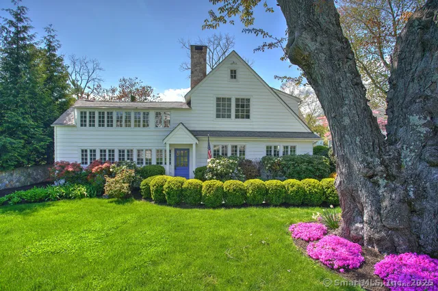 a front view of house with yard and trees