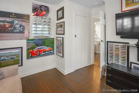 a view of a livingroom with wooden floor and a fireplace