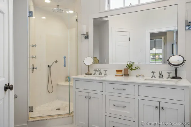 a bathroom with a shower sink and mirror